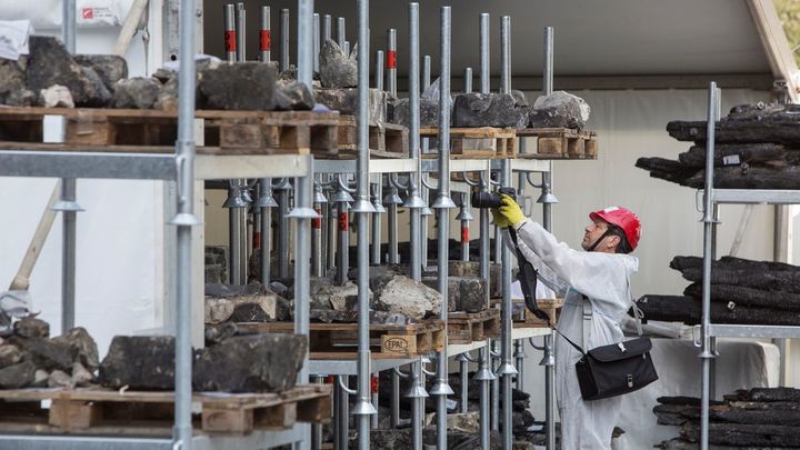 Historiador fotografía restos históricos almacenados frente a Notre Dame / EFE