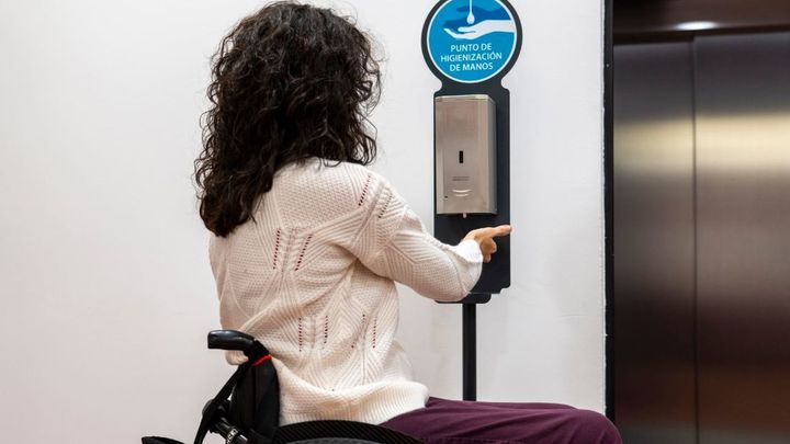 Una persona en silla de ruedas en un punto de higienización de manos / Fundación ONCE