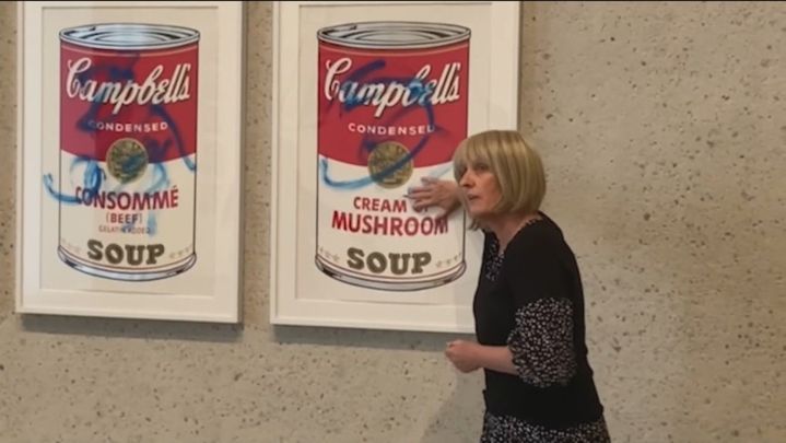 Una activista ecologista se 'pega' en Australia a una de las famosas ilustraciones de las latas de Campbells de Andy Wharhol / REDACCIÓN