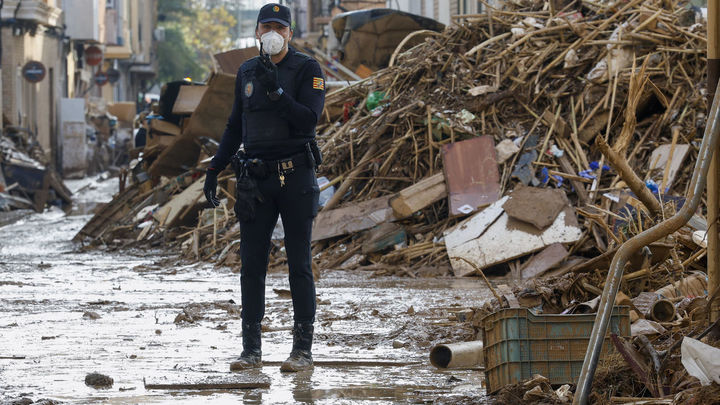 Un policía en medio de la DANA / EFE